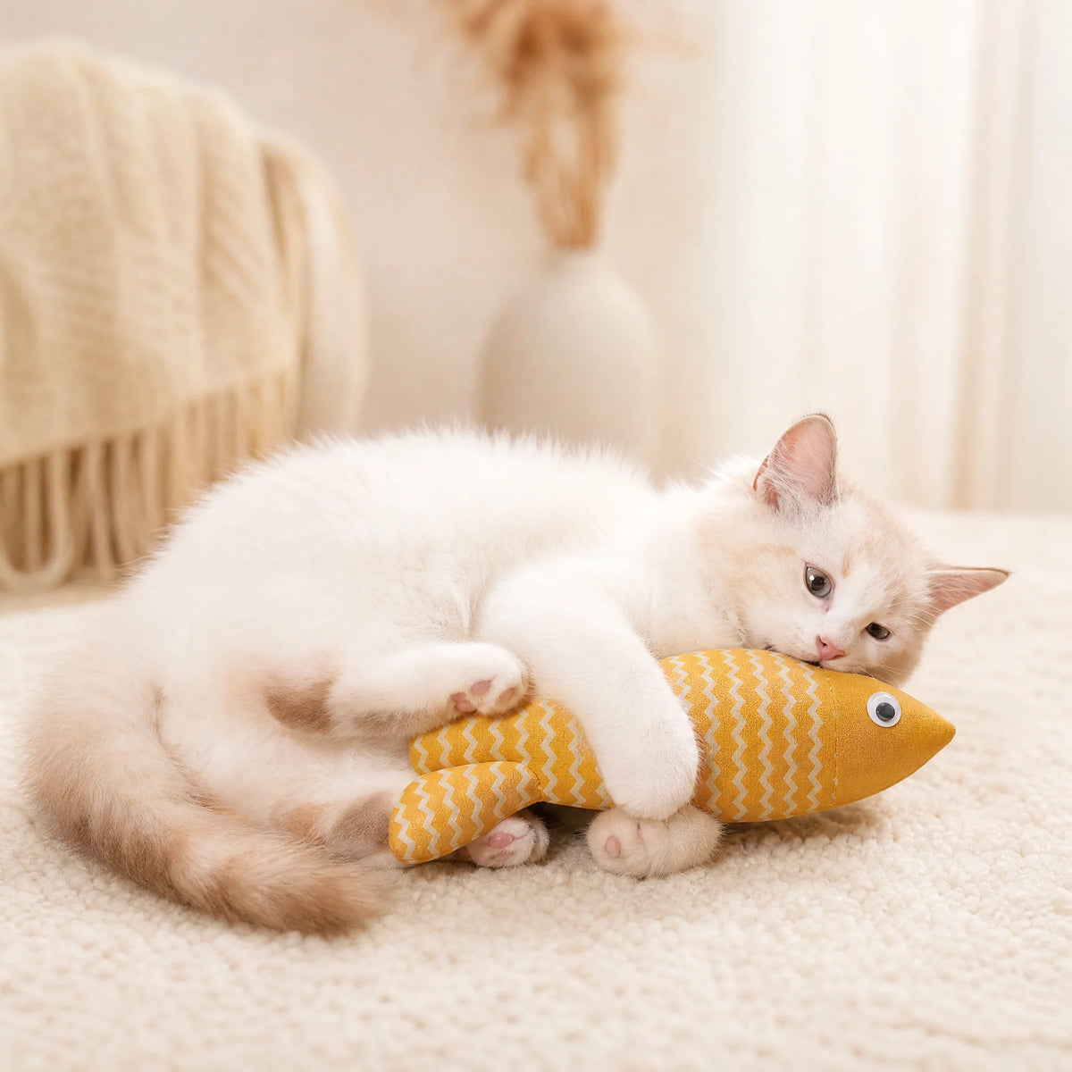 Cat biting the burlap fishbone cat toy while holding it with front paws